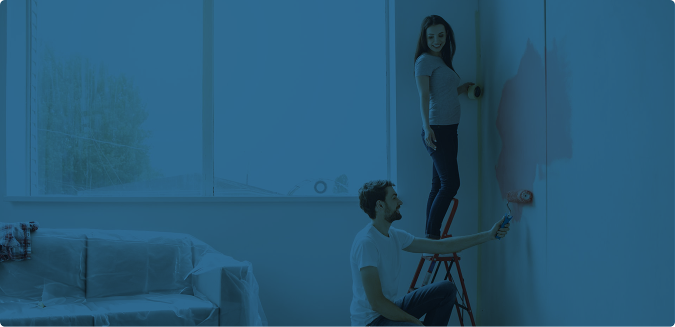 Paint roller applying blue paint to a wall
