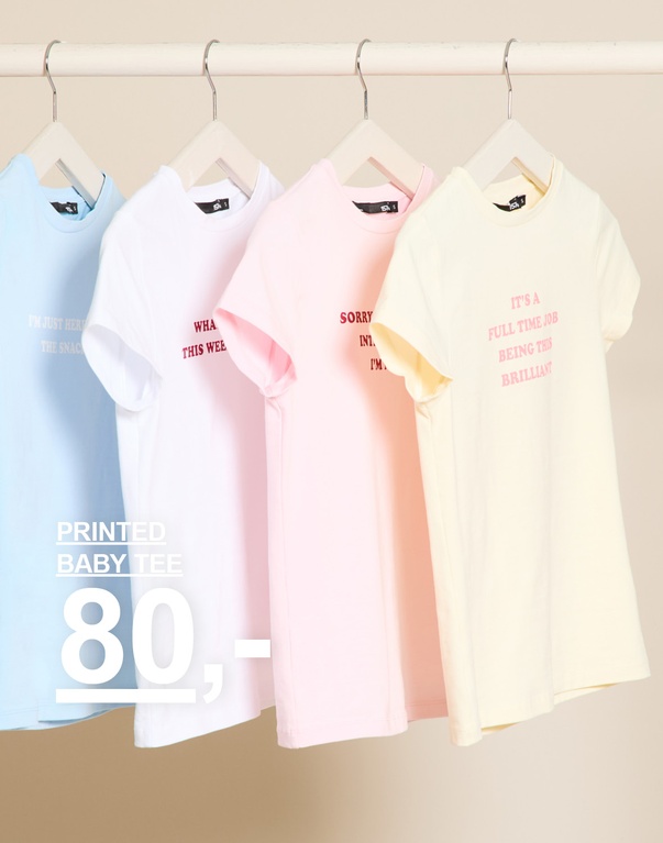 Printede t-skjorter i lyseblå, hvit, lys rosa og lys gul. Kampanjetekst: "PRINTED BABY TEE, 80,-".