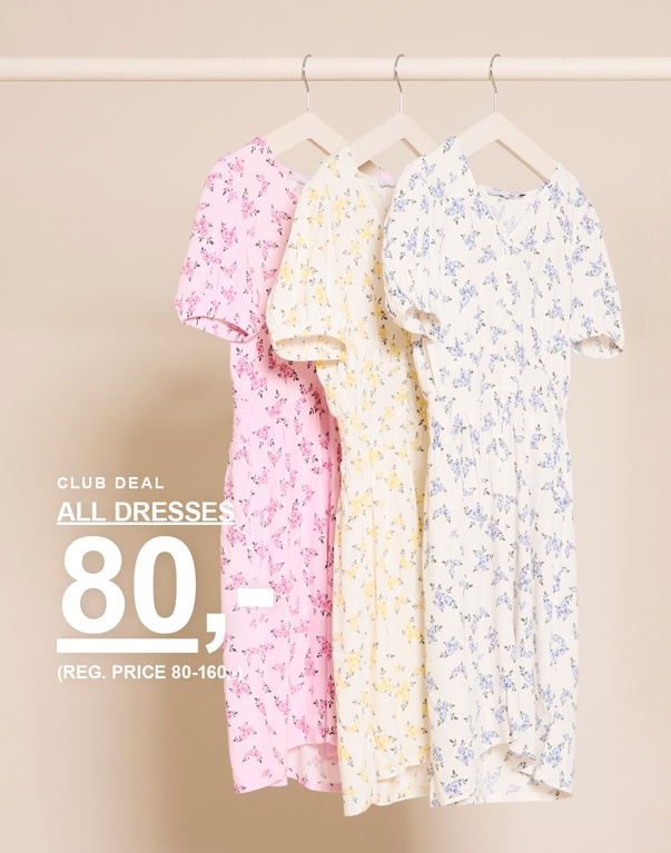 Tre blomstrede kjoler i farverne lyserød, gul og hvid på bøjler foran en lys baggrund. CLUB DEAL ALL DRESSES 80,- (REG. PRICE 80-160,-)
