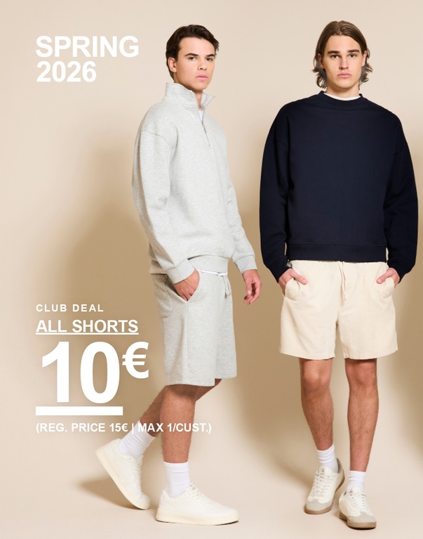 Kaksi miestä shortseissa – toisella harmaa collegepaita ja harmaat shortsit, toisella tumma collegepaita ja vaaleat shortsit beigeä taustaa vasten. SPRING 2026. CLUB DEAL. ALL SHORTS 10€ (REG. PRICE 15€ | MAX 1/CUST.)