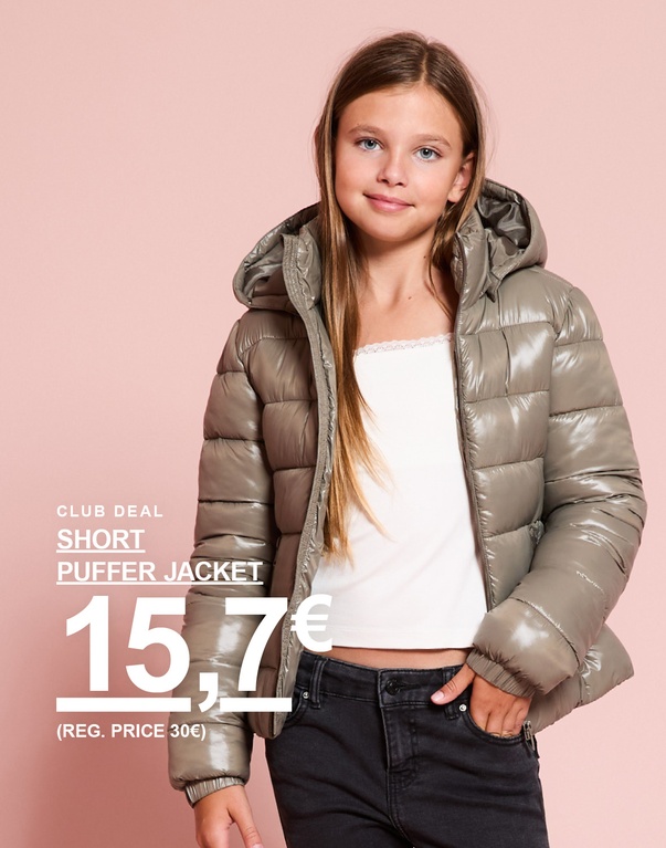 Mädchen mit kurzer, grüner Pufferjacke vor rosafarbenem Hintergrund. Club Deal: Short Puffer Jacket 15,7€ (reg. Preis 30€).