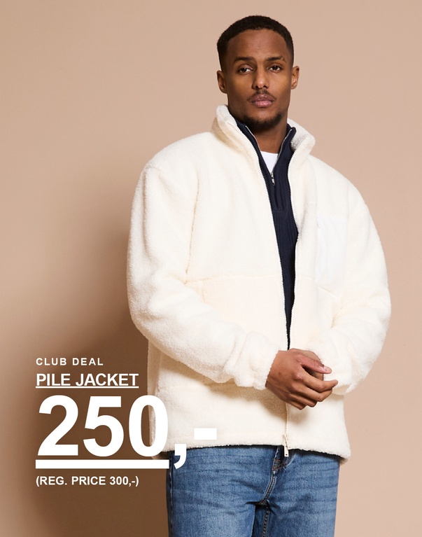 Mann i hvit pilejakke med glidelås og jeans mot lys bakgrunn. Kampanjetekst: ”CLUB DEAL PILE JACKET 250,- (REG. PRICE 300,-)”.