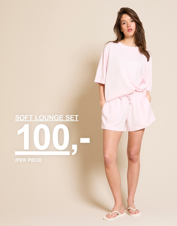Jente i sett med t-skjorte og shorts i lys rosa. Kampanjtext: 'SOFT SCUBA SET, 100,-/PER PIECE'.