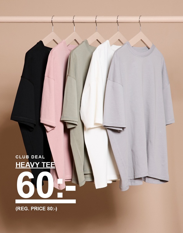 Fem enfärgade t-shirts i svart, rosa, grönt, vitt och grått på galgar mot beige bakgrund. Kampanjtext: ”CLUB DEAL HEAVY TEE 60:- (REG. PRICE 80:-)”.