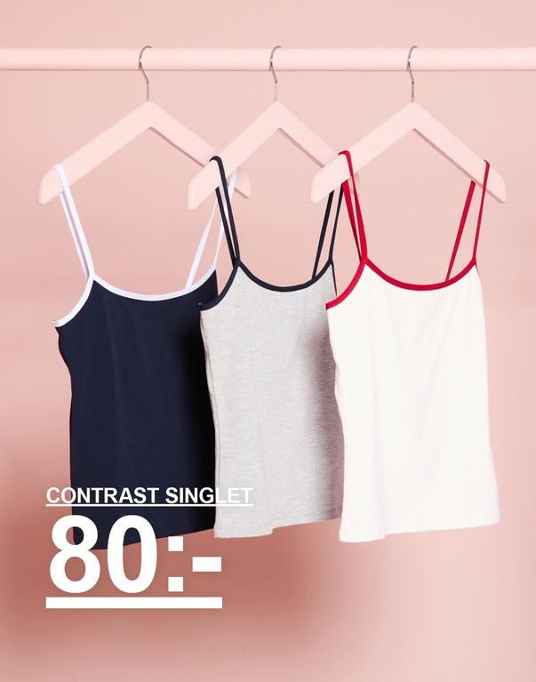 Tre contrast linnen i mörkblått, gråmelerat och vitt med röda detaljer. Kampanjtext: "CONTRAST SINGLET 80:-"