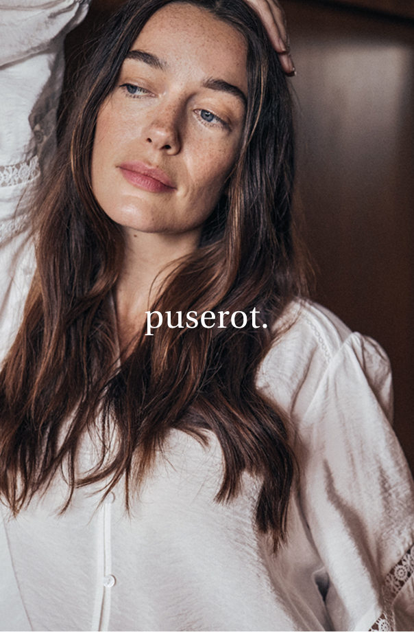 Kuva naisesta valkoisessa puserossa.