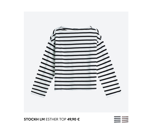 Valkoinen naisten pitkähihainen pusero, jossa mustat raidat.