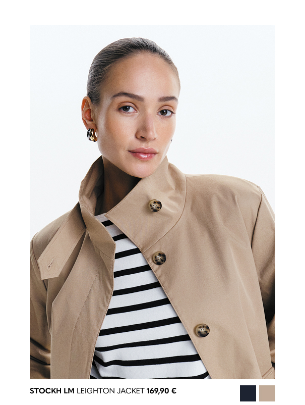 Valkoinen naisten pitkähihainen pusero, jossa mustat raidat.