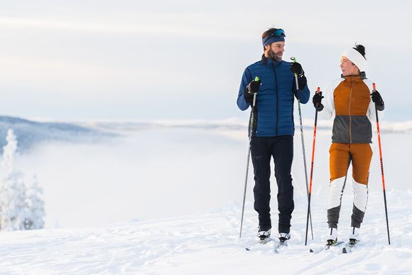 Två personer med Nordic längdskidkläder kollektionen 