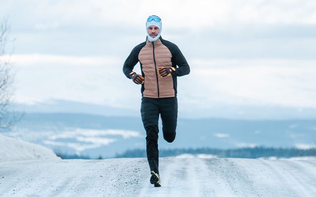 en man ligger i blåbärsriset med friluftskläder från Swedemount