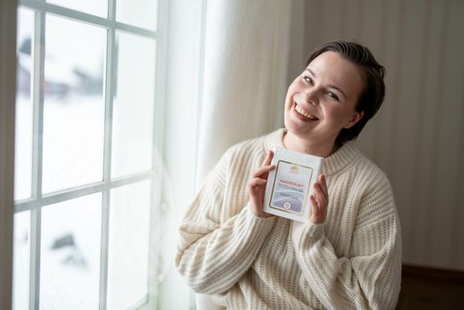woman holding magnesium supplement smiling