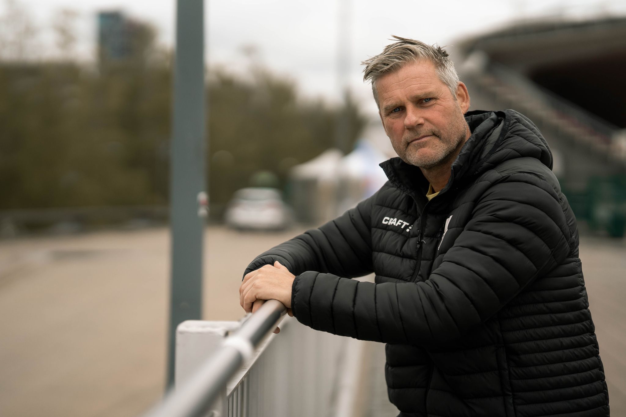 man leaning on fence