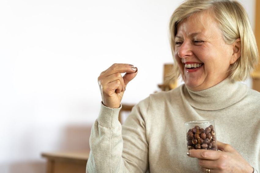 woman holding a nut smiling
