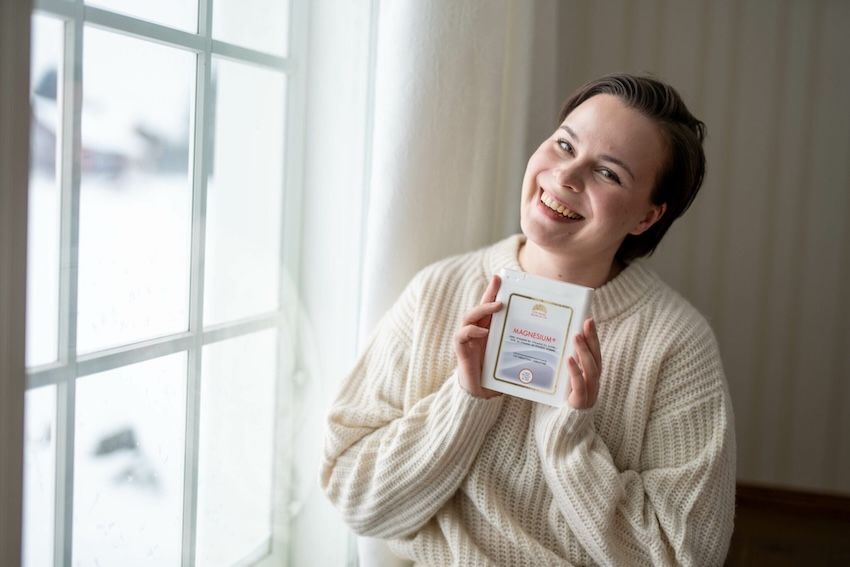 woman holding magnesium supplement